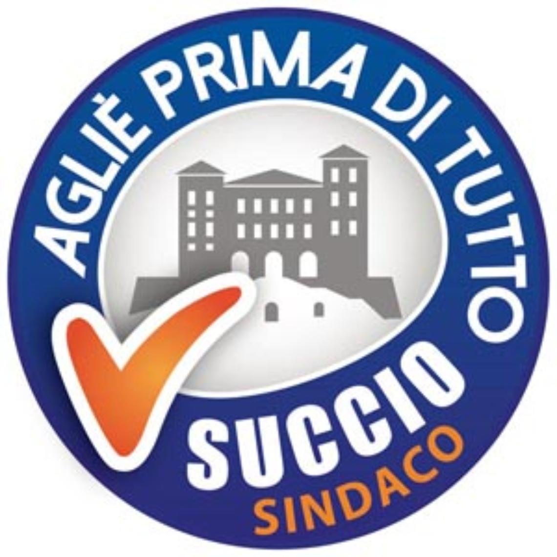 AGLIE'. Succio presenta il logo della lista e ribatte alle accuse