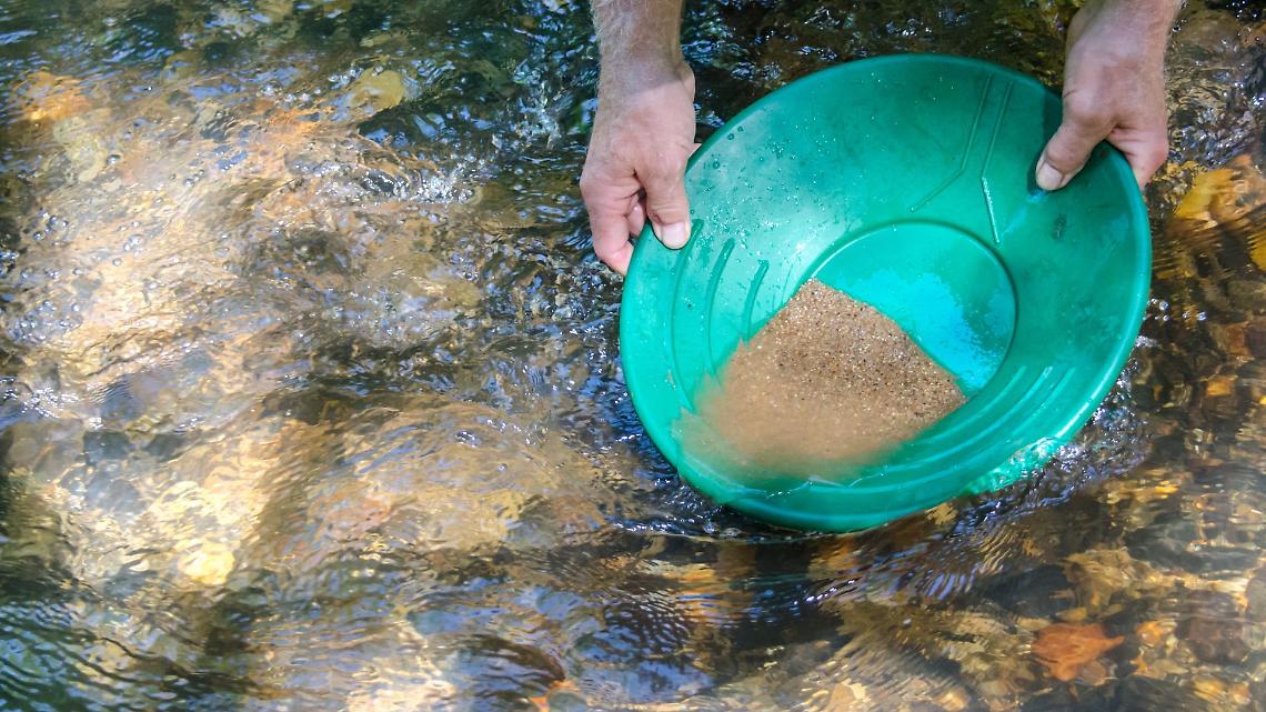 Cerca oro nel fiume con pompa elettrica (foto di archivio)