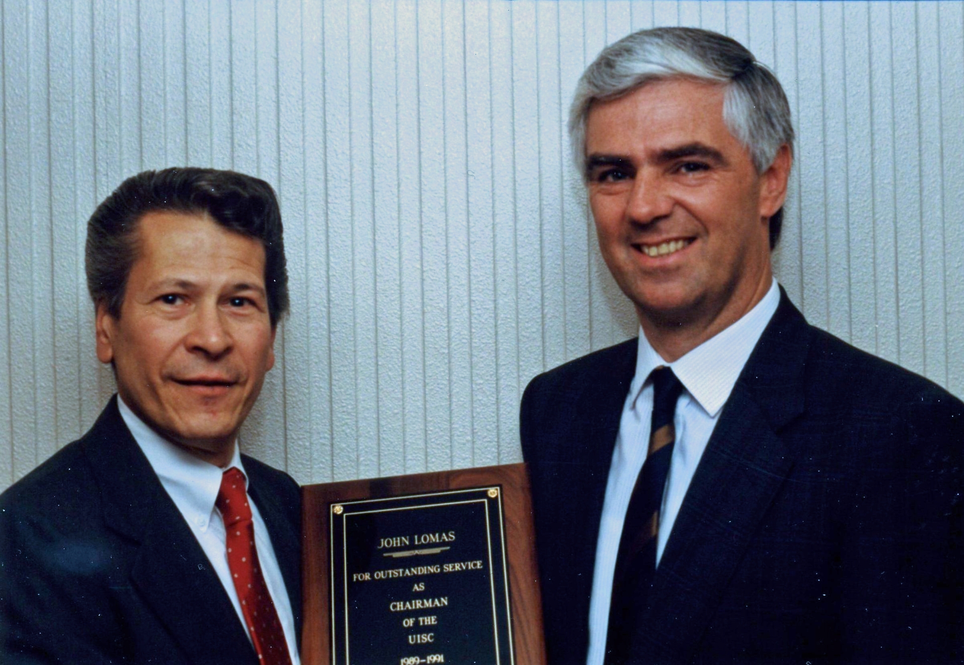 Left to right, Mr. John Lomas, director of UNIX Strategic Alliance, Olivetti; Mr. Peter Stuart, marketing manager, UNIX Systems Group, ICL; departing and newly appointed UISC Chair, respectively.